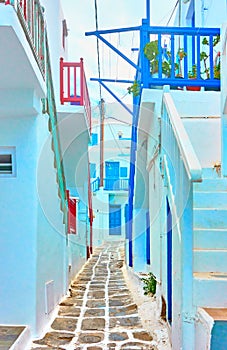 Narrow street with small whitewashed houses in Mykonos