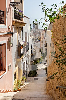 Narrow street with stairs in Barrio Santa Cruz in Alicante, Costa Blanca, Spain