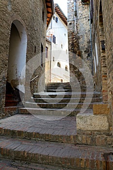 Narrow street and stairs in San Gimignano in Tuscany, Italy.