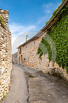 Narrow street, stone houses and ivy in an ancient village