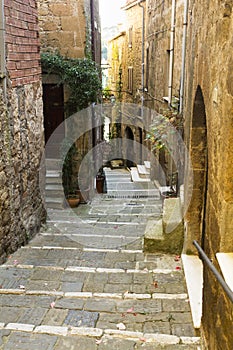 Narrow street with stone stairs in a town from Tuscany
