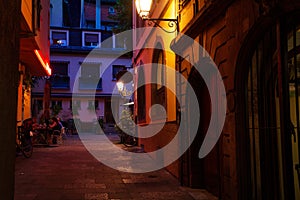 Narrow street of Strasbourg city at night, France