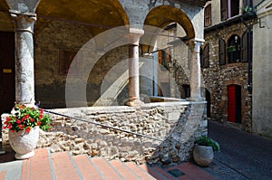 Narrow street in town of Sirmione, Italy. Church of Santa Maria Maggiore XV century