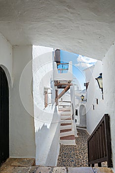 Narrow street in the traditional fishing village of Binibeca on the coast of Menorca, Spain.