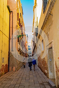 Narrow street with traditional old Venetian houses Italy