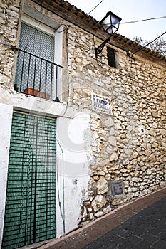 Narrow street and typical facade of Benifato village photo