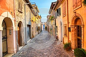 Narrow street of the village of fishermen San Guiliano with colorful houses and a bicycle in early morning in Rimini, Italy photo