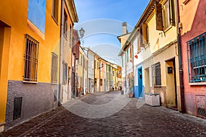 Narrow street of the village of fishermen San Guiliano with colorful houses and bicycles in early morning in Rimini, Italy photo