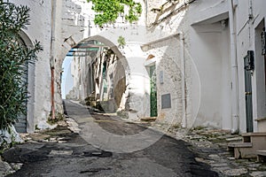 Narrow street in white city of Ostuni, Puglia, Italy