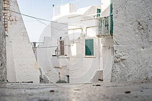 Narrow street in white city of Ostuni, Puglia, Italy