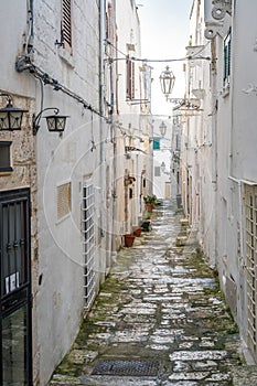 Narrow street in white city of Ostuni, Puglia, Italy