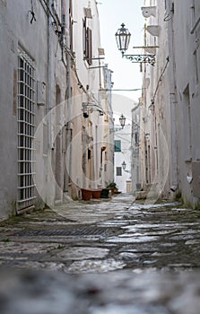 Narrow street in white city of Ostuni, Puglia, Italy