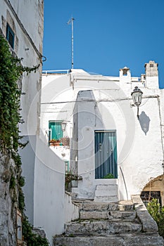 Narrow street in white city of Ostuni, Puglia, Italy