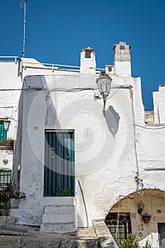 Narrow street in white city of Ostuni, Puglia, Italy