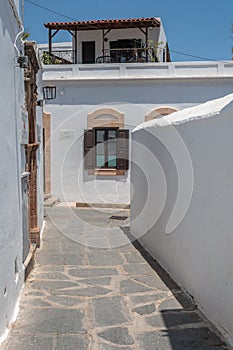 Narrow street with white walls taken in lindos rodos greece