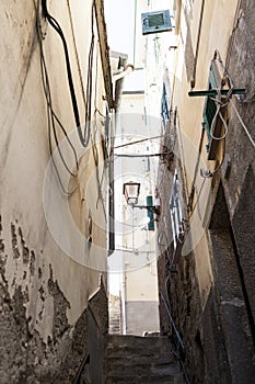 The narrow streets of the city of Genoa Italy. Old cobblestone road in the window grilles. Beautiful Perspective Lane. A good