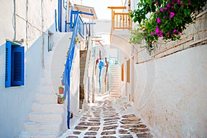 The narrow streets of greek island with blue balconies, stairs and flowers. Beautiful architecture building exterior