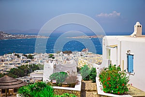 The narrow streets of greek island with blue balconies, stairs and flowers. Beautiful architecture building exterior