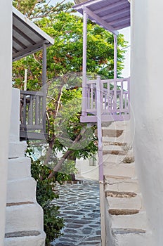 The narrow streets of the island with blue balconies and stairs