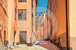 Narrow streets in old city with windows, cobbled stones and historical houses. View of Stockholm, Sweden.