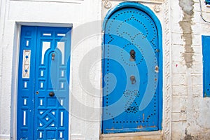 Narrow streets of old town medina in Sousse, Tunisia. Traditional Tunisian blue doors