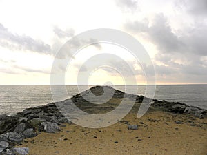 Narrow strip of land across the sea in the evening