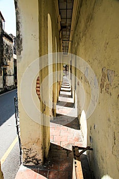 Narrow sunny alley, old town somewhere in asia