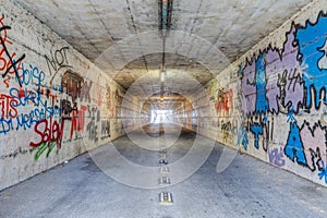 Narrow tunnel with graffiti