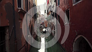 Narrow Venice street with lone boat. Scenic view of Venice canal with old houses