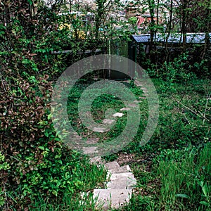 Narrow way with stones in a homeyard