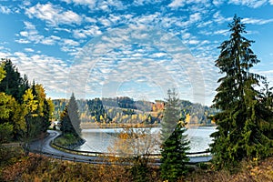 Narrow winding road along the lake, autumn landscape
