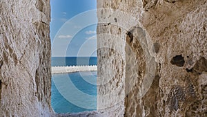 A narrow window opening in the walls of the ancient Citadel of Qaitbay.