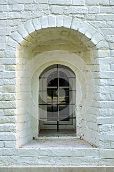 Narrow window in the wall of an ancient building in the Joseph-Volotsky russian monastery