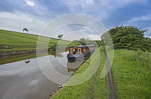 Narrowboat on a British canal in rural setting