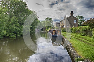 Narrowboat on a British canal in rural setting