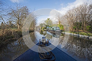 Narrowboat on a British canal in rural setting