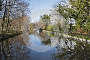 Narrowboat on a British canal in rural setting