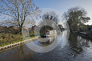 Narrowboat on a British canal in urban setting