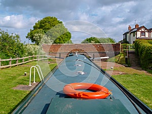 Narrowboat in canal lock.