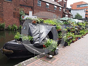 Narrowboat selling plants on the Fazeley Canal in the centre of Birmingham, England