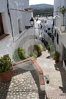 A narrowed, stepped alleyway in the old quarter of the Spanish village of Frigiliana on the Costa del Sol.