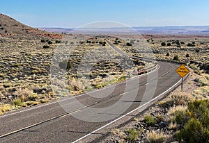 Narrowing road thru desert landscape