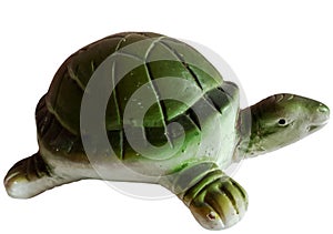 A green turtle statue on a white background. photo