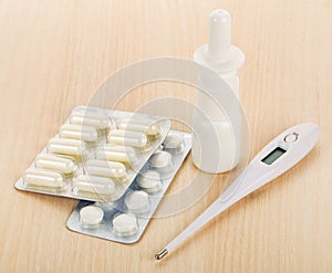 Nasal spray, capsules and thermometer