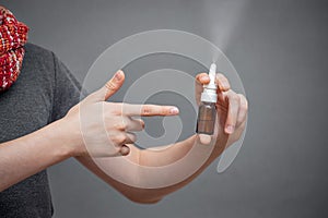 Nasal spray in a glass bottle in hands close-up