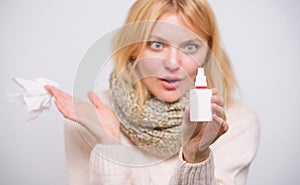 Nasal spray using. Cute woman nursing nasal cold or allergy. Unhealthy girl with runny nose using nasal spray. Treating