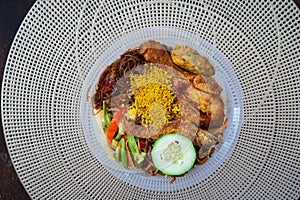 Nasi Ambeng or Nasi Ambang. It is a fragrant rice dish that consists of steamed white rice, chicken curry or chicken stewed in soy