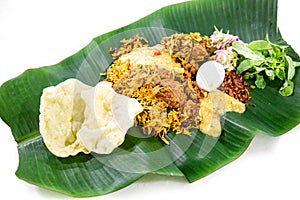 Nasi briyani with lamb mutton served on banana leaf plate