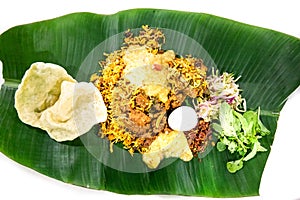 Nasi briyani with lamb mutton served on banana leaf plate