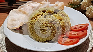 Nasi kebuli is a savory spiced rice dish found in Indonesia. photo